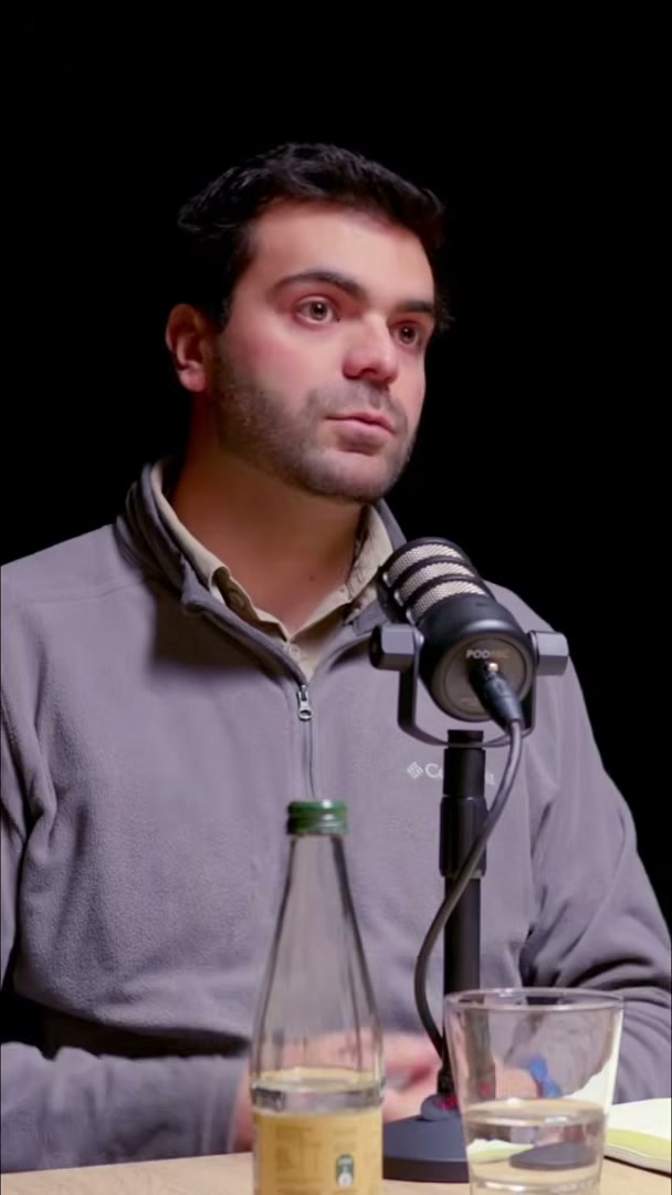Podcast guest speaking in CHR Chile Registros' dark studio